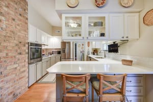Kitchen peninsula with seating area and modern cabinets.